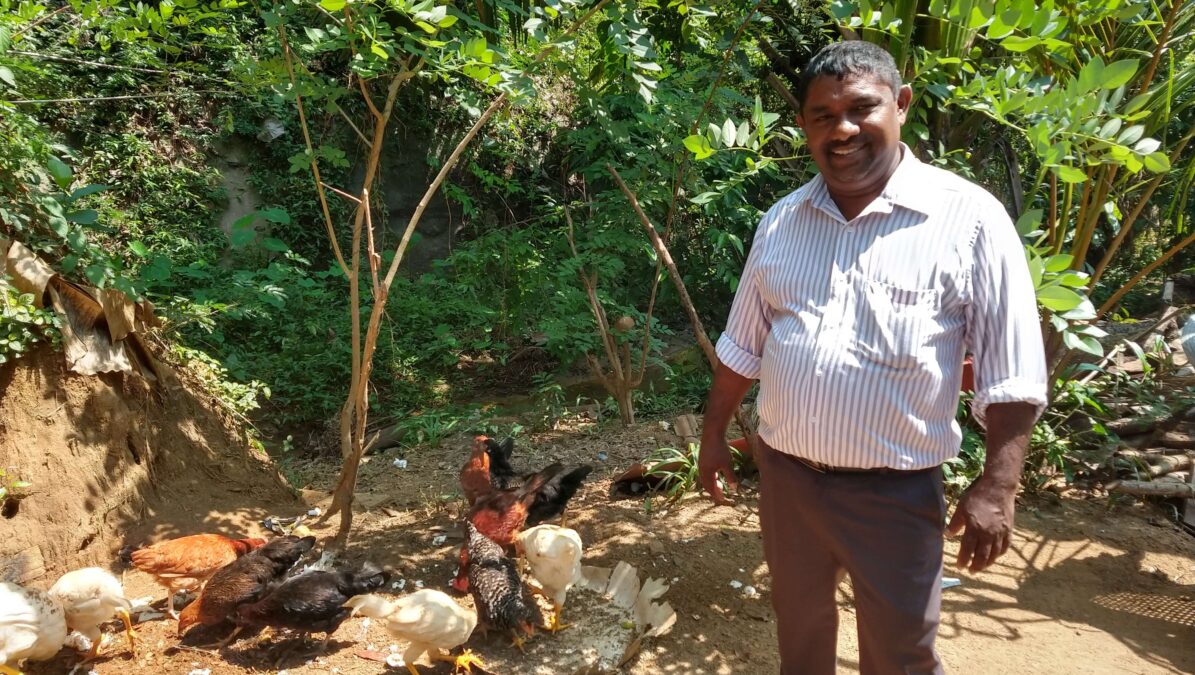 Priest in Sri Lanka with his chickens